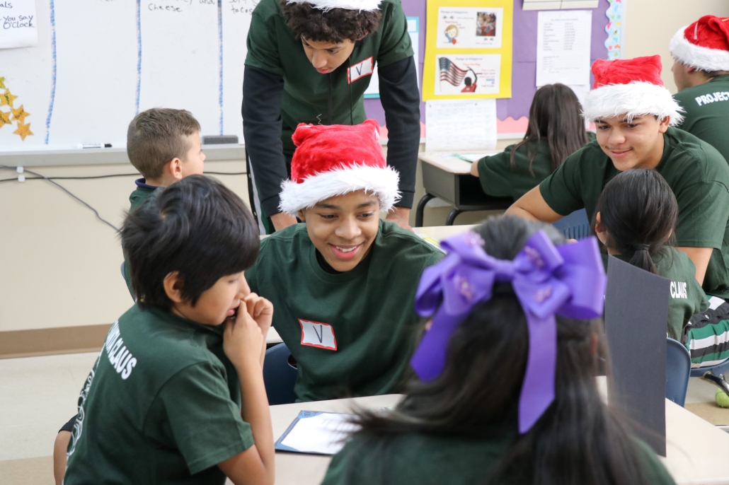 Tylik smiling with two HIL students