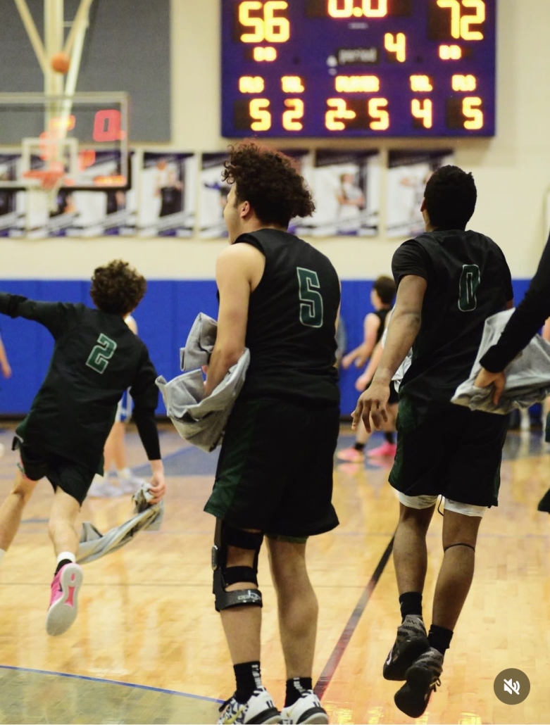 Athletes celebrating with winning scoreboard in the background