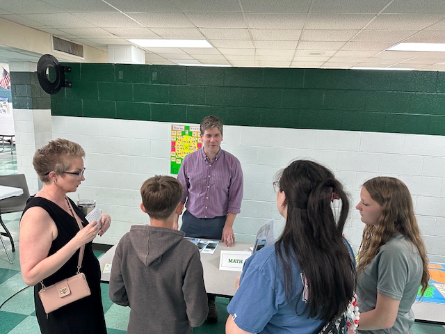 Mr. Sterwerf at math table with attendees