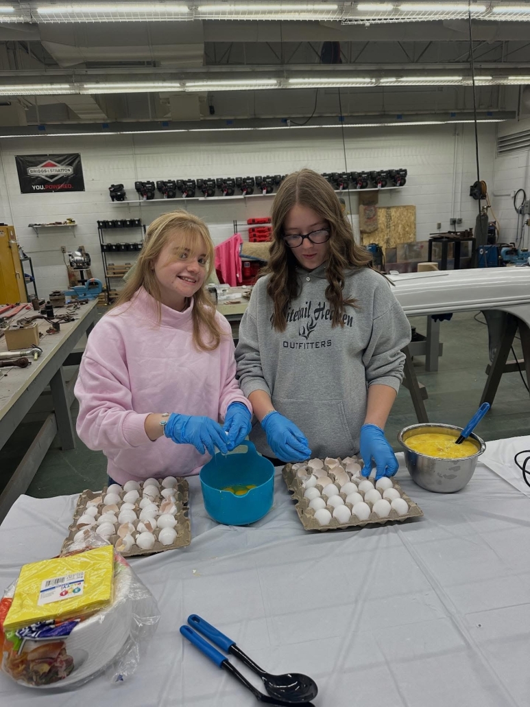 Jula and Hailey cracking eggs