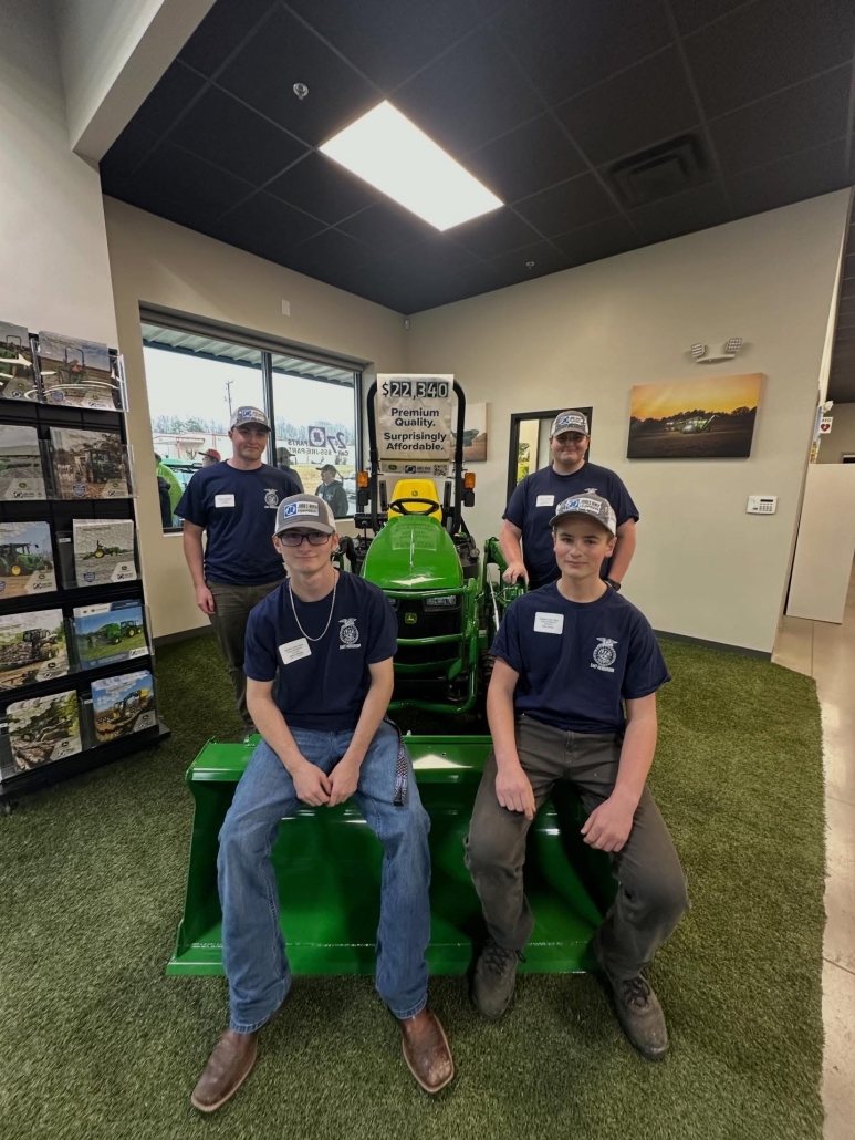 Four boys in front of John Deere