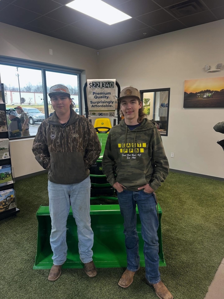 Two boys in front of John Deere