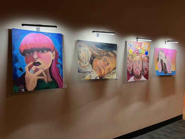 4 student art pieces lit up 1
