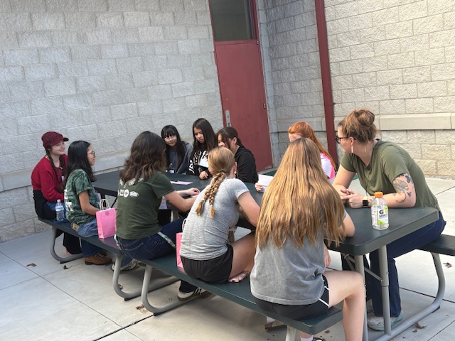 GEM girls at picnic table talking - whole group