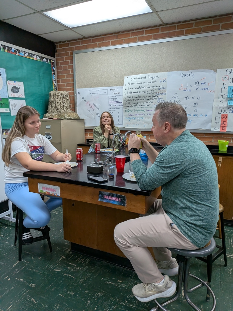 students and Mr. Scott enjoying Rice Day treats