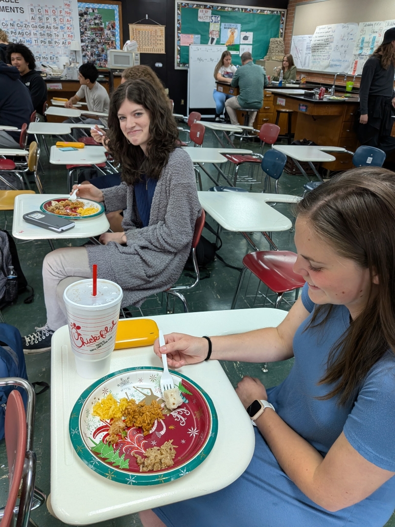 Katie and Clara enjoying Rice Day treats at desks