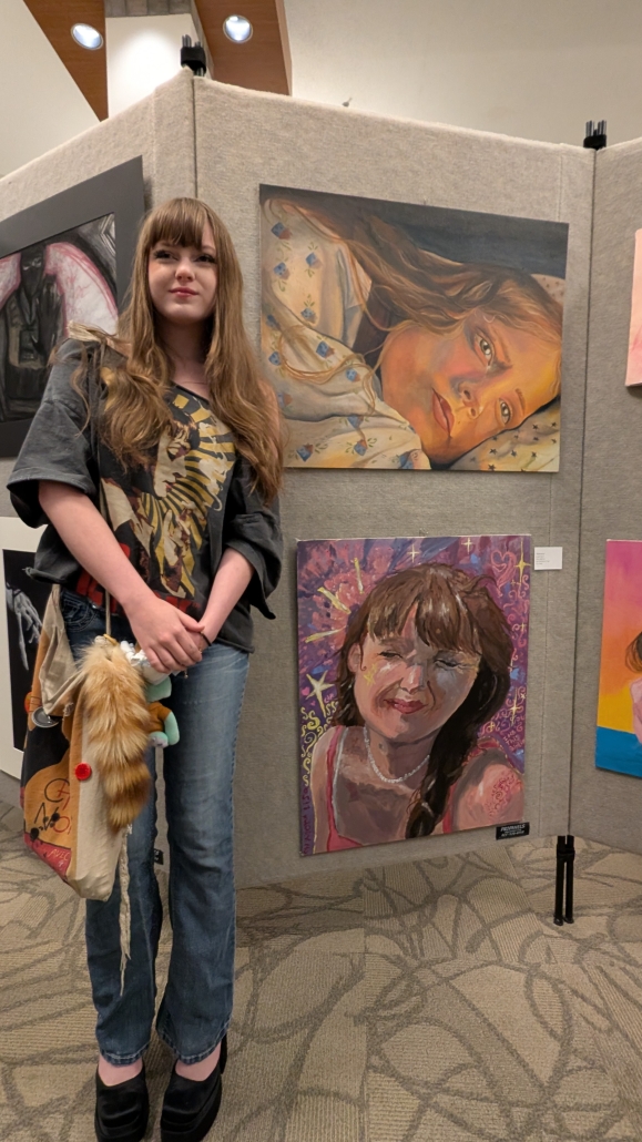 Jade with her artwork at the art show