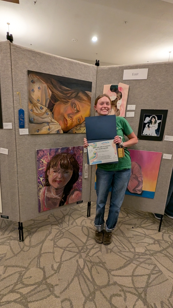 Elizabeth with her artwork at the art show