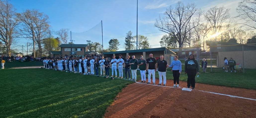staff and players lined up for the National Anthem