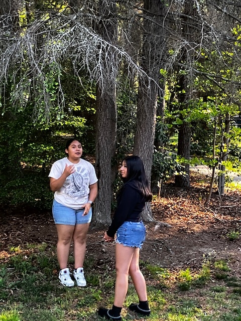 two girls practicing translation outside