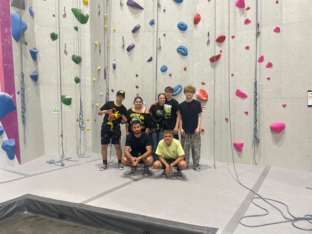 Group photo in front of rock wall