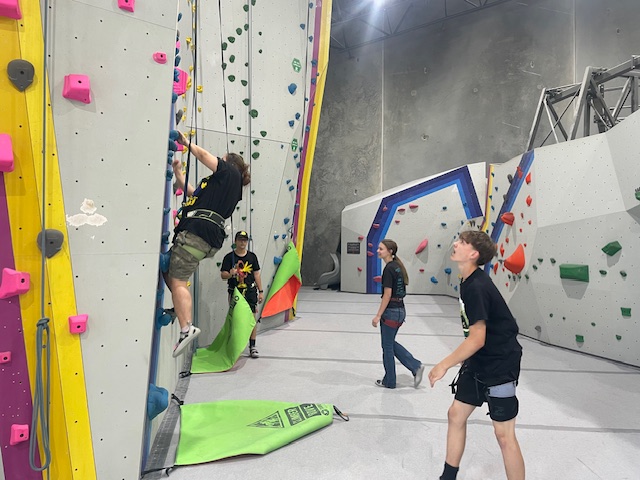 Students climbing and spotting 