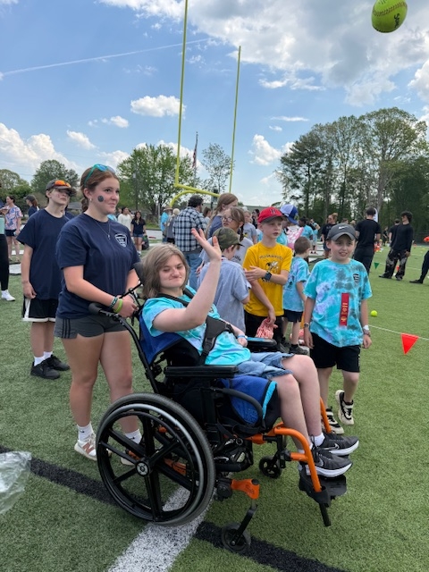 Alyssa doing softball throw with Leila