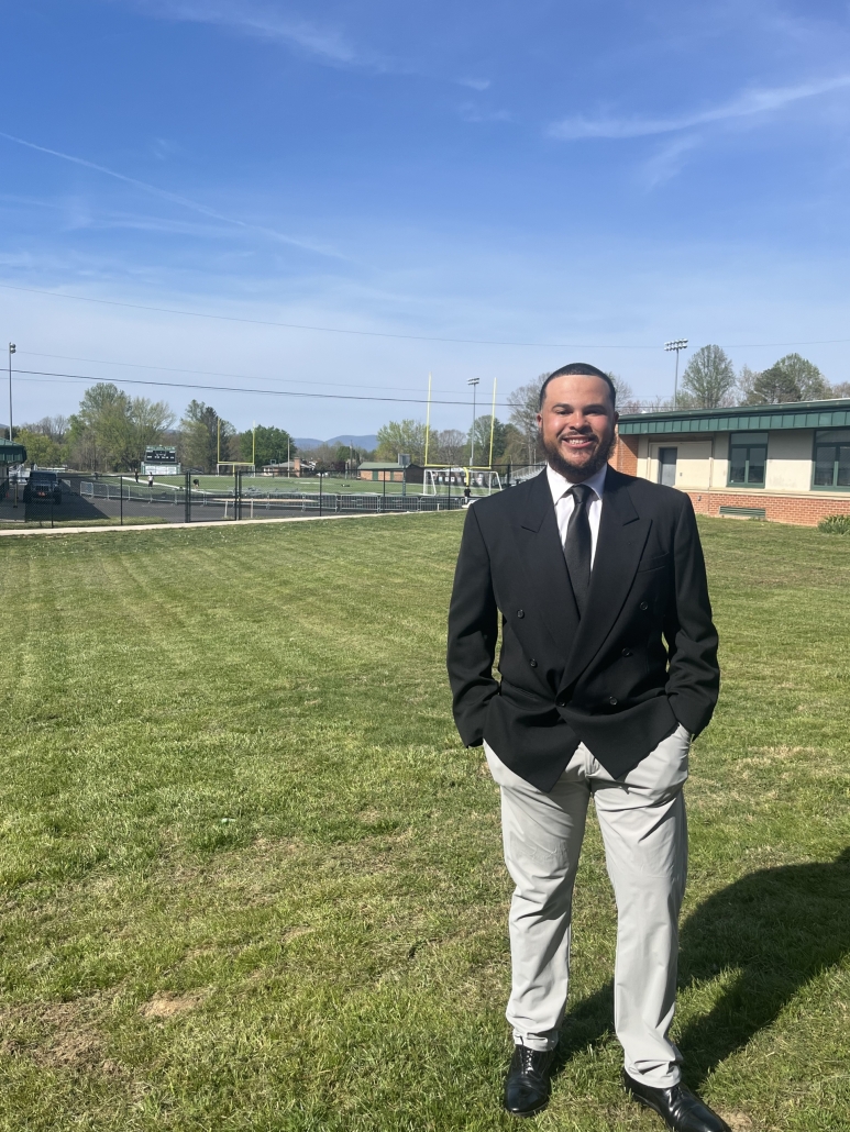 Coach Rudisill with football field in the background