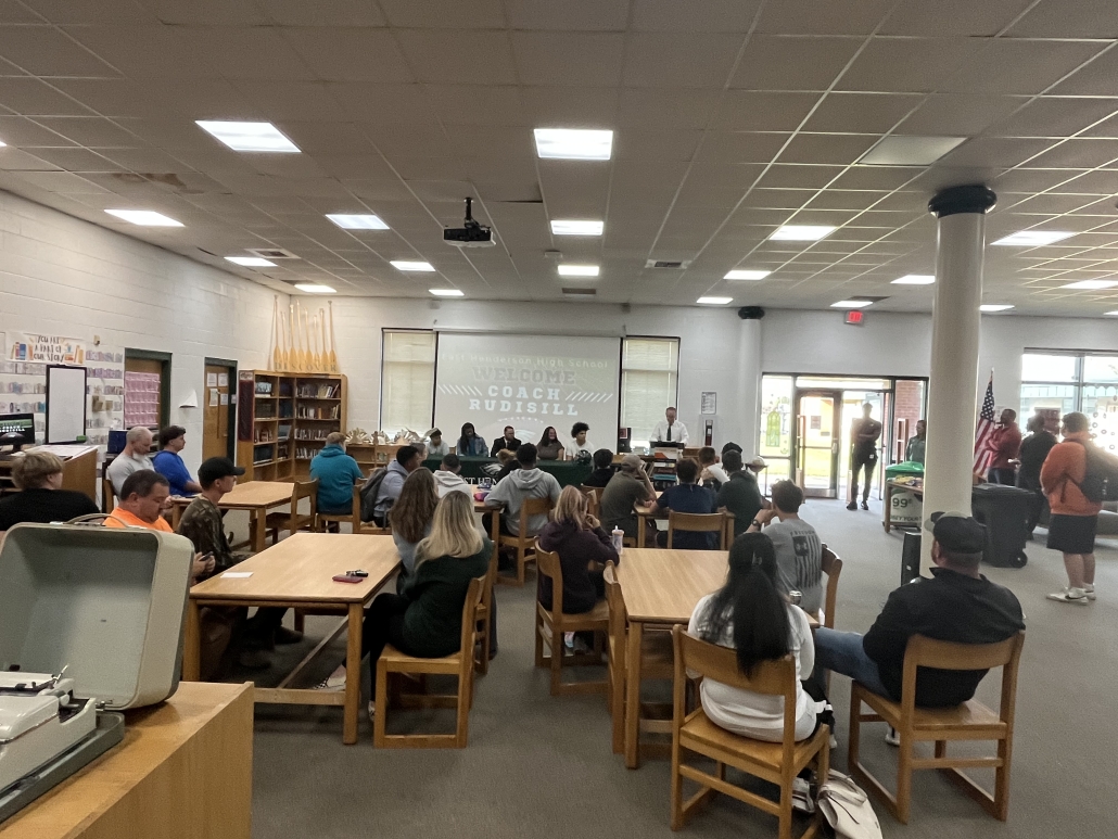 media center filled with people for coach announcement