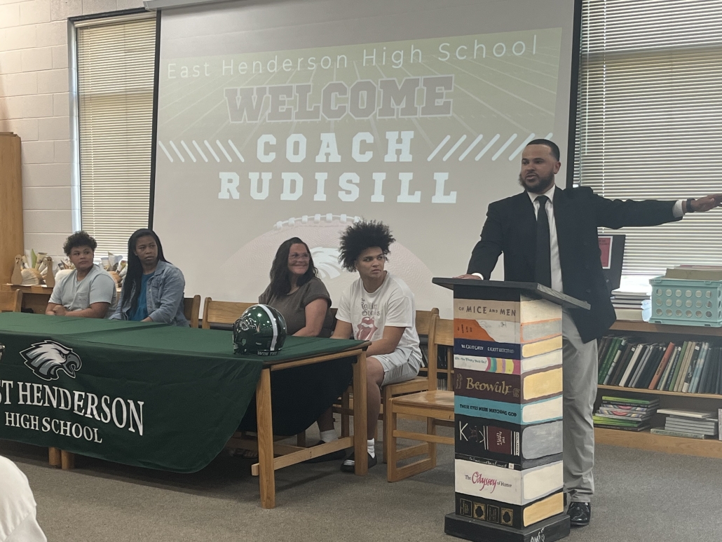 Coach Rudisill speaking at podium 