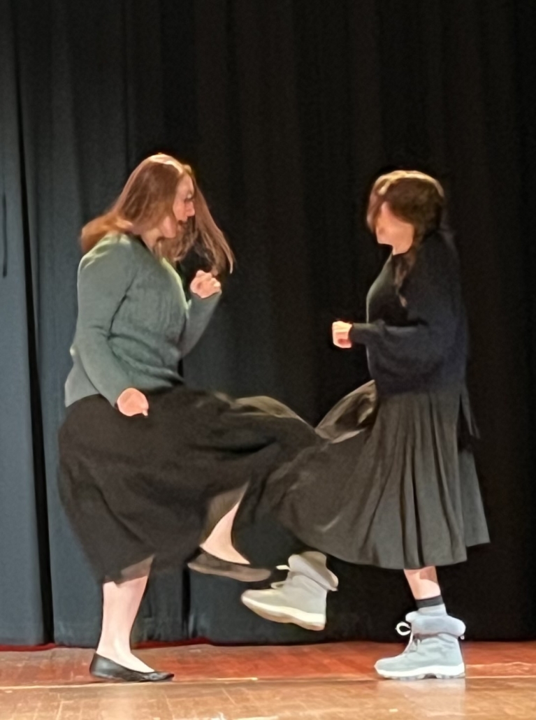 Mrs. Adair and Ms. Focarino dancing on stage