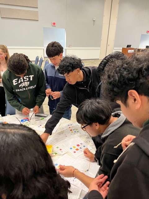 Students working on leadership ID bracelets