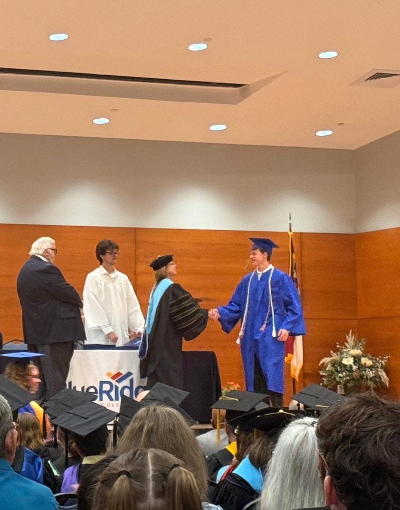 Tristan walking the stage at graduation