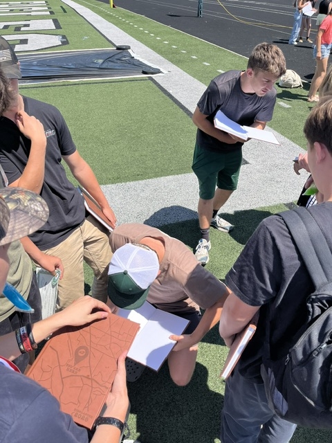 group of boys signing yearbooks