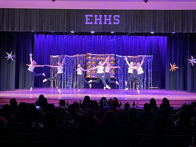 group dance with purple lights
