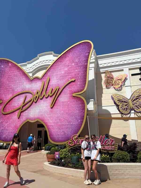 Two girls in front of Dolly butterfly sign