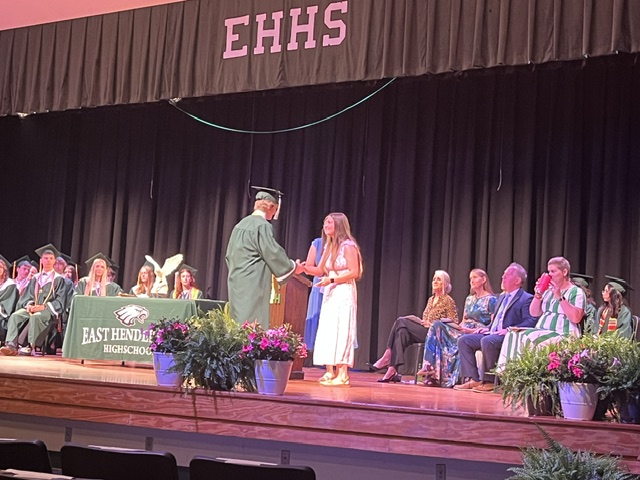 Camp GLOW Award recipient shaking hands