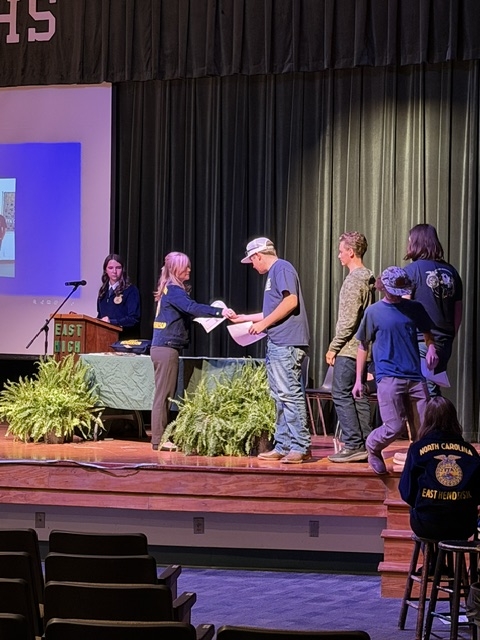 Students shaking hands with new members