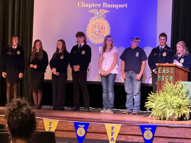 Officers on stage standing in a line