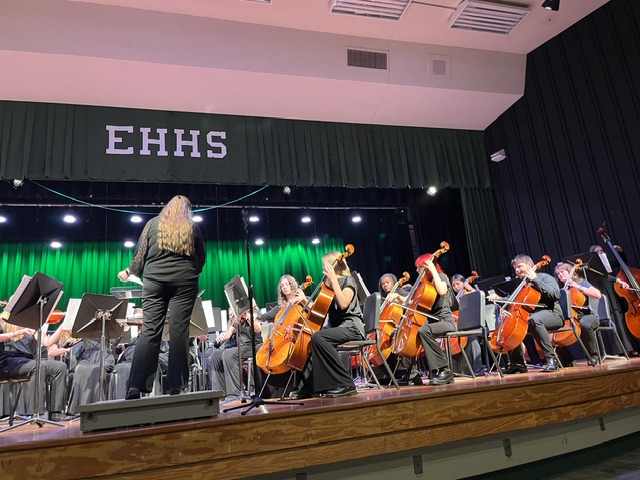 Mrs. Quinn conducting orchestra