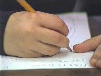 Child writing with pencil