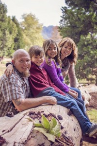 Family sitting on a log