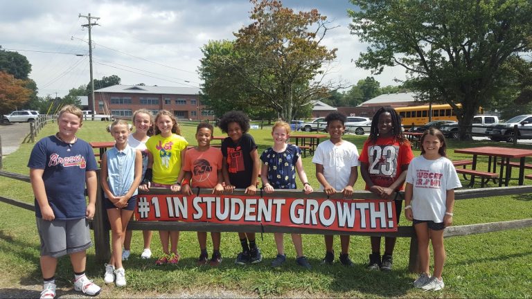 Students in front of sign