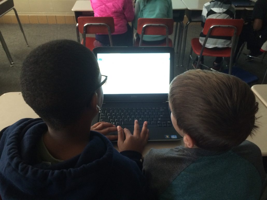 2 students at a laptop doing coding activities