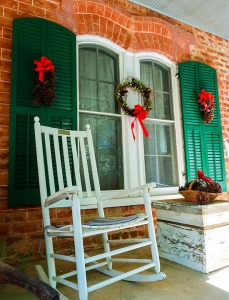 Christmas décor adorns the farm house porch.