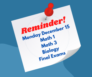Light blue background with a white sticky note pinned by a red pushpin. The note displays "Reminder!" in red text at the top, followed by "Monday December 15" and a list of subjects: "Math 1, Math 3, Biology Final Exams" in blue text. The note appears to have a slight shadow effect.