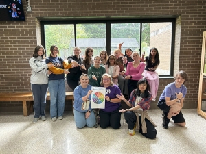 image of students standing in front of a window