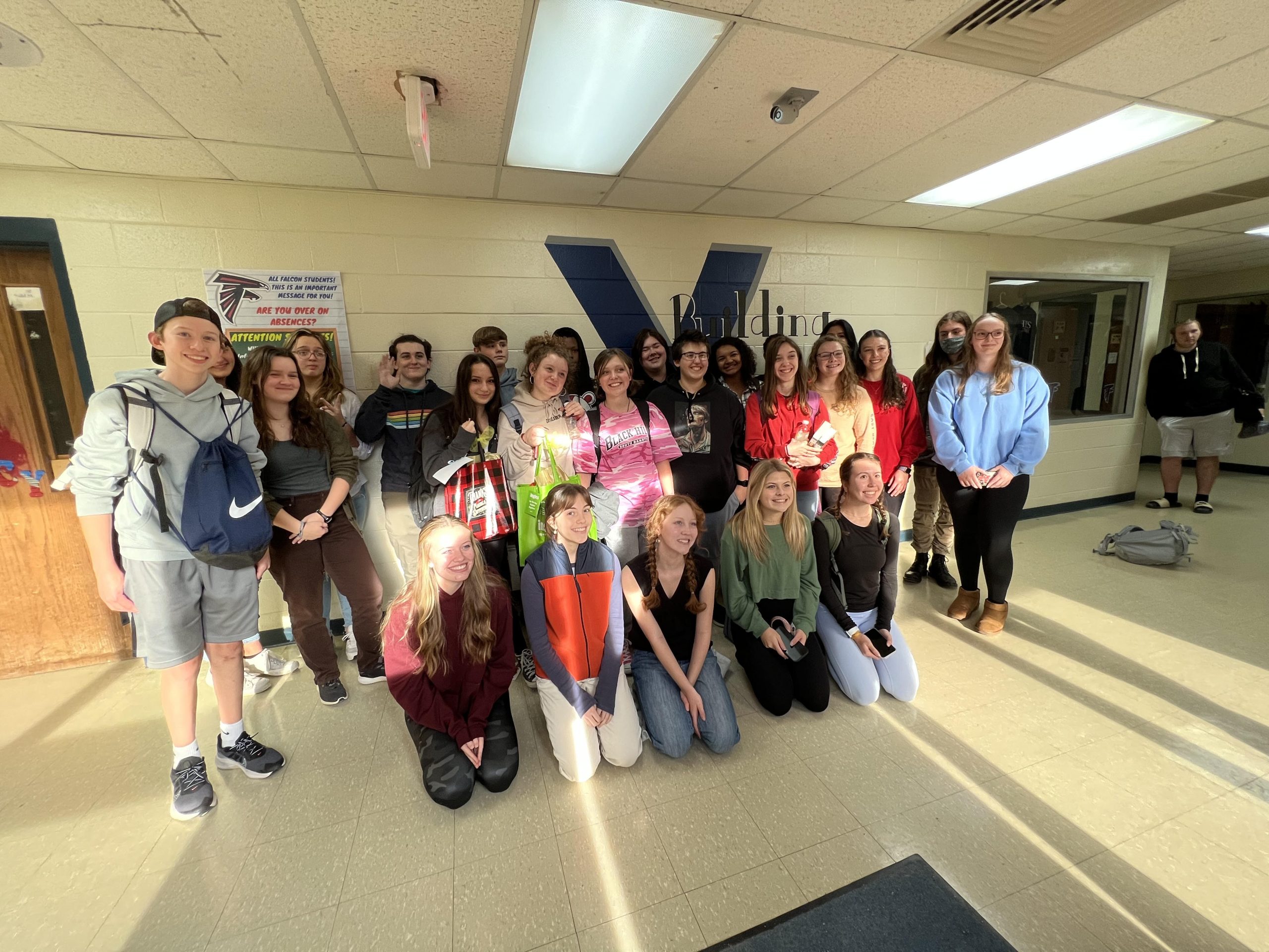 many students pose after helping fill thanksgiving bags for the community