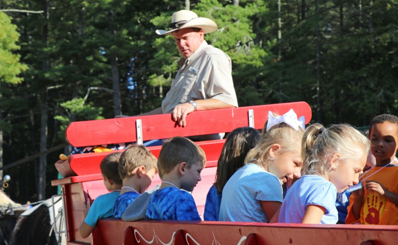 Students ride a wagon.