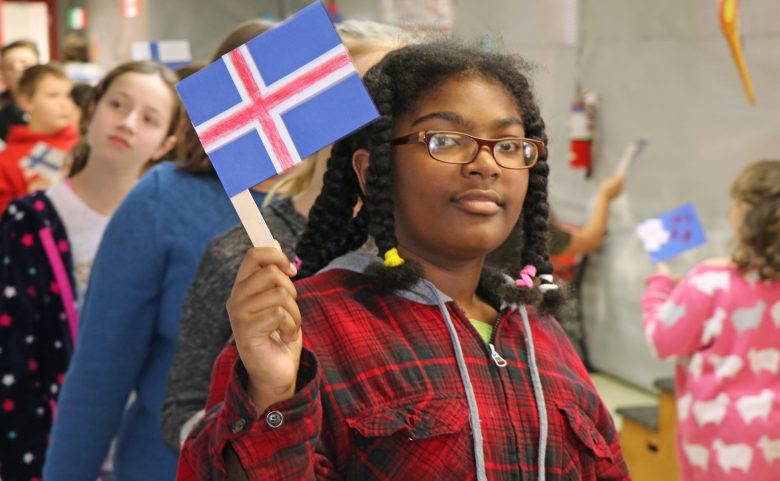 Student holding a country's flag