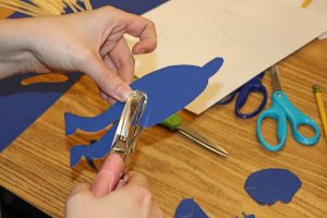 A teacher makes a puppet joint.