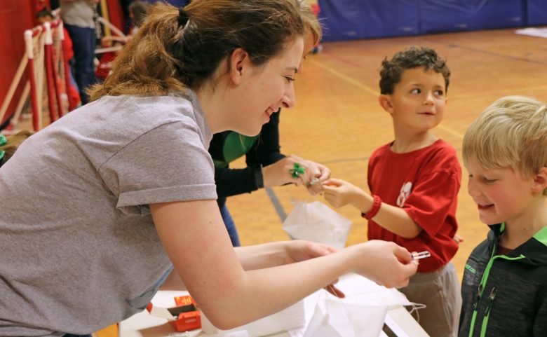 Early College student helps an elementary student with a project