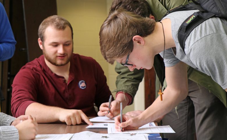 Students at North help their peers fill out voter registration forms.