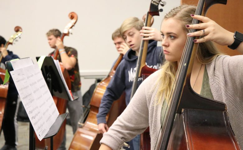 Students playing upright basses