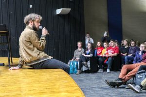 Nat Zegree speaks to students at West Henderson High.