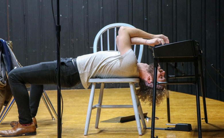 Nat Zegree plays the keyboard upside down at West Henderson High