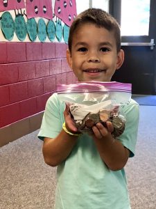 Student with Ziploc bag of coins.