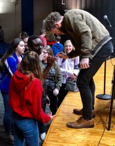 Nat Zegree signing student autographs.