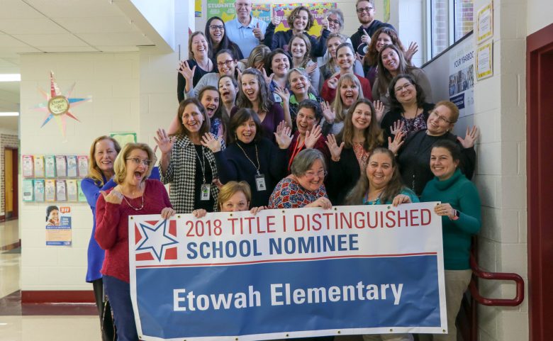 Etowah Elementary staff with "2018 Title I Distinguished School" Nominee sign