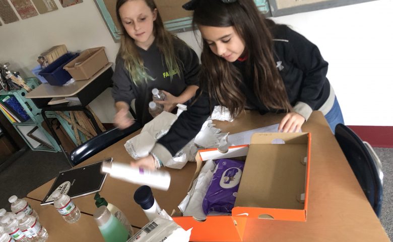 Students pack shoeboxes with donations